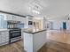 Open concept kitchen with stainless steel appliances and center island at 471 Deer Run, Pittsboro, NC 27312