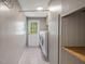 Functional laundry room with washer and dryer, shelving, and convenient access to the exterior at 471 Deer Run, Pittsboro, NC 27312
