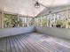 Enclosed porch with wood flooring and views of the surrounding trees at 471 Deer Run, Pittsboro, NC 27312