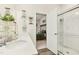 Bright bathroom with double sinks, shower, and a view of the bedroom, offering convenience and modern design at 501 Campbell Ridge Pl, Wendell, NC 27591