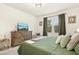 Bedroom with a wooden dresser and television, complemented by neutral décor and comfortable furnishings at 501 Campbell Ridge Pl, Wendell, NC 27591