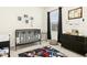 Charming Bedroom featuring a sleek black crib and playful sneaker-themed decor and rug at 501 Campbell Ridge Pl, Wendell, NC 27591