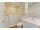 Bright bathroom featuring a walk-in bathtub, a white vanity, and a mirrored medicine cabinet at 505 #106 Alamance Rd, Burlington, NC 27215