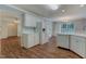Bright kitchen with wood floors, white cabinets, and stainless refrigerator at 505 #106 Alamance Rd, Burlington, NC 27215