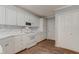 Kitchen with white cabinets, modern appliances, and laminate wood flooring at 505 #106 Alamance Rd, Burlington, NC 27215