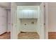 A compact laundry room with white cabinets above hookups, accessible through double doors at 505 #106 Alamance Rd, Burlington, NC 27215