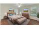 Bright bedroom with neutral decor, ceiling fan and beautiful wood floors at 505 #106 Alamance Rd, Burlington, NC 27215