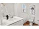 Bright bathroom features a white vanity, hardwood floors, and contemporary design at 613 Canal St, Durham, NC 27701