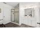 Bright bathroom features double sinks, modern lighting, and walk-in shower with glass door at 613 Canal St, Durham, NC 27701