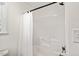 Clean bathroom featuring a shower with curtain and a window for natural light at 613 Canal St, Durham, NC 27701