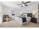 Comfortable bedroom with carpet, ceiling fan, and a cozy reading chair near the window at 613 Canal St, Durham, NC 27701