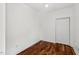 Simple bedroom featuring hardwood floors and a double door closet at 613 Canal St, Durham, NC 27701