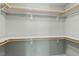 Walk-in closet with built-in shelving and wooden rods for ample storage space at 613 Canal St, Durham, NC 27701