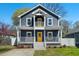 Charming two-story home with a welcoming front porch, yellow door, and well-maintained lawn at 613 Canal St, Durham, NC 27701