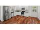 Modern kitchen with stainless steel appliances, white cabinets, and beautiful hardwood floors at 613 Canal St, Durham, NC 27701
