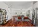 Open-concept living area featuring hardwood floors, recessed lighting, and stainless steel refrigerator at 613 Canal St, Durham, NC 27701