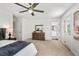 Spacious main bedroom with a ceiling fan, ensuite bathroom, and an antique wooden dresser at 613 Canal St, Durham, NC 27701