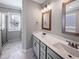 Bathroom featuring double vanity sinks, a glass enclosed shower, and modern fixtures at 6233 Reagan Ln, Wake Forest, NC 27587