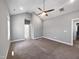 Bedroom with carpet, light grey walls, ceiling fan, and two entryways visible at 6233 Reagan Ln, Wake Forest, NC 27587