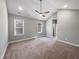 Bright bedroom boasts high ceilings, a modern ceiling fan and two large windows at 6233 Reagan Ln, Wake Forest, NC 27587
