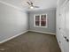 A bright bedroom featuring neutral carpeting, light grey walls, and a window offering natural light at 6233 Reagan Ln, Wake Forest, NC 27587