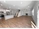 Open layout combines kitchen, living, and staircase to upper level. Hardwood floor throughout at 6233 Reagan Ln, Wake Forest, NC 27587
