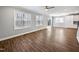Living room showcases wood floors and abundant natural light from large windows at 6233 Reagan Ln, Wake Forest, NC 27587