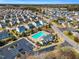 Community aerial view showcases a neighborhood pool, clubhouse, and neatly arranged single-Gathering homes on manicured streets at 6817 Osprey Landing Dr, Wendell, NC 27591