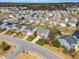 This aerial view shows a neighborhood with tidy houses, trimmed lawns, quiet streets, and many houses with fenced backyards at 6817 Osprey Landing Dr, Wendell, NC 27591