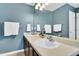 Bathroom featuring double sinks, a large mirror, and ample counter space at 6817 Osprey Landing Dr, Wendell, NC 27591