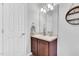 Clean bathroom featuring a vanity with a large mirror and modern lighting fixtures at 6817 Osprey Landing Dr, Wendell, NC 27591