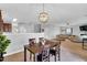 Inviting dining room showcasing an elegant light fixture, an open-concept design, and neutral paint at 6817 Osprey Landing Dr, Wendell, NC 27591