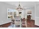 Bright dining room featuring hardwood floors, a modern light fixture, and natural lighting at 6817 Osprey Landing Dr, Wendell, NC 27591