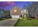 Charming two-story home featuring a brick facade, red shutters, a well-maintained lawn, and a two car garage at 6817 Osprey Landing Dr, Wendell, NC 27591