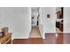 Neutral hallway featuring hardwood floors and an open view of the living spaces at 6817 Osprey Landing Dr, Wendell, NC 27591