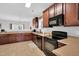 Functional kitchen featuring ample cabinet space, a black appliance package, and neutral countertops at 6817 Osprey Landing Dr, Wendell, NC 27591