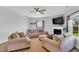 Bright living room showcasing neutral furniture, a fireplace, and ample natural light at 6817 Osprey Landing Dr, Wendell, NC 27591