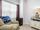 Bright bedroom featuring a comfortable chair, decorative details, and ample natural light at 700 Treviso Ln, Apex, NC 27502
