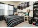 Charming bedroom with patterned bedspread, city art, and abundant natural light at 700 Treviso Ln, Apex, NC 27502