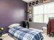 Cozy bedroom with accent wall, records, and a comfortable blue plaid bedspread at 700 Treviso Ln, Apex, NC 27502