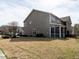 Back of home with a large yard with a patio area at 700 Treviso Ln, Apex, NC 27502