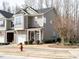 Exterior view of a well-maintained townhouse with a tidy front yard at 700 Treviso Ln, Apex, NC 27502