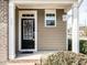 Close-up of a welcoming front door with decorative wreath and sidelight window at 700 Treviso Ln, Apex, NC 27502