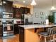 Inviting kitchen with stainless steel appliances, granite countertops, and a breakfast bar at 700 Treviso Ln, Apex, NC 27502