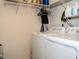 Functional laundry room with washer, dryer, and shelving for storage at 700 Treviso Ln, Apex, NC 27502
