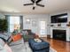 Cozy living room featuring a fireplace and plenty of natural light at 700 Treviso Ln, Apex, NC 27502