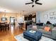 Spacious living room featuring hardwood floors, dining area and a view of the kitchen at 700 Treviso Ln, Apex, NC 27502