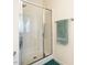 Bathroom with clear glass enclosed shower and a towel rack with a green towel at 700 Treviso Ln, Apex, NC 27502