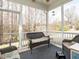 Inviting screened porch with comfortable wicker seating, perfect for relaxing outdoors at 700 Treviso Ln, Apex, NC 27502