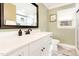 Modern bathroom with marble countertops, white cabinetry, and glass-enclosed shower at 703 Sybil Dr, Durham, NC 27703